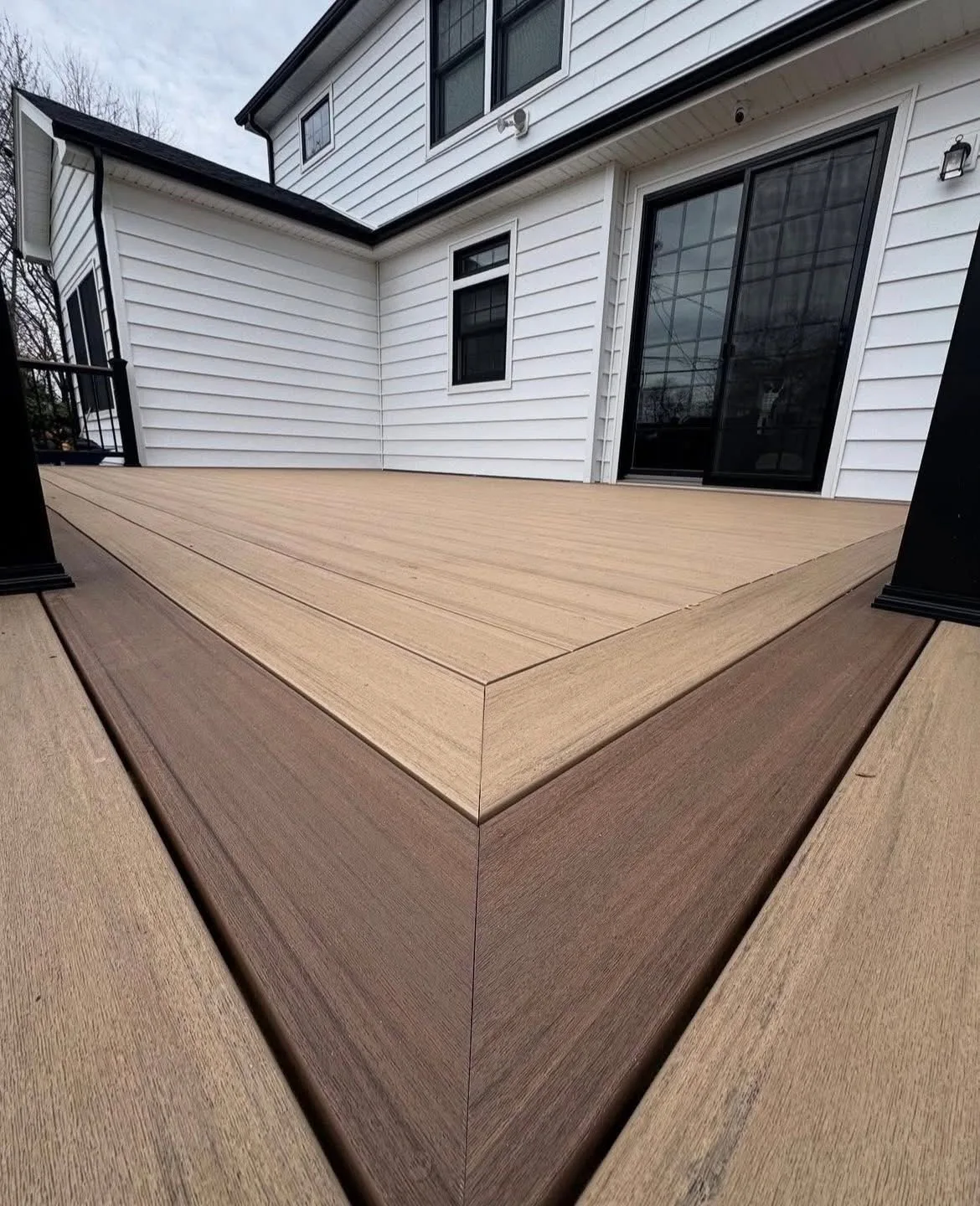 Close view of a tan composite deck corner with a mitred picture frame border